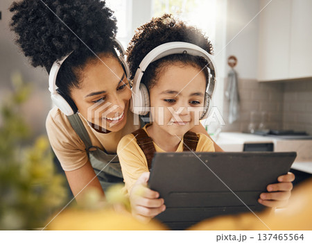 Mother, child and tablet with headphones, smile or excited for movie, music or streaming subscription. Mom, kid and digital touchscreen for education, learning or help for online class in family home Mother, child and tablet with headphones, smile or excited for movie, music or streaming subscription. Mom, kid and digital touchscreen for education, learning or help for online class in family home 137465564