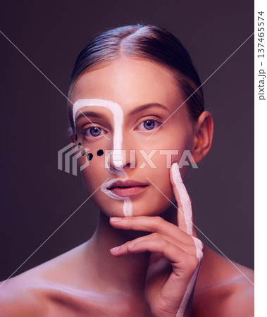 Art, makeup and portrait of woman in studio with creative, beauty and abstract face aesthetic. Cosmetic, artistic and headshot of young female model from Canada with facial paint by black background. Art, makeup and portrait of woman in studio with creative, beauty and abstract face aesthetic. Cosmetic, artistic and headshot of young female model from Canada with facial paint by black background. 137465574