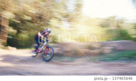 Blur, race and man cycling in nature training for a competition on trail in forest or woods. Action, sports or fast cyclist athlete riding bicycle at speed for cardio exercise, fitness or workout Blur, race and man cycling in nature training for a competition on trail in forest or woods. Action, sports or fast cyclist athlete riding bicycle at speed for cardio exercise, fitness or workout 137465646