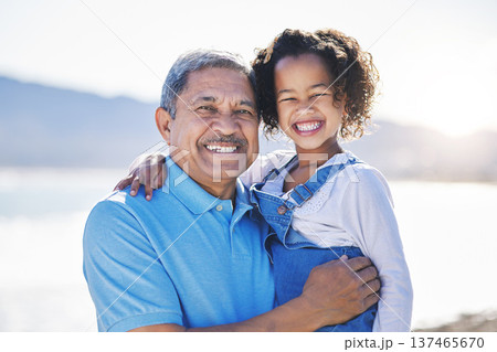 Happy, beach and portrait of child with grandfather on a vacation as travel together on outdoor holiday for happiness. Hug, smile and grandparent with kid or grandchild by ocean or sea for adventure 137465670