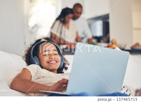 Child, laptop and headphones on sofa for happy video streaming, audio subscription and e learning at home. Kid relax on couch listening to music, games and online education on computer in living room Child, laptop and headphones on sofa for happy video streaming, audio subscription and e learning at home. Kid relax on couch listening to music, games and online education on computer in living room 137465715