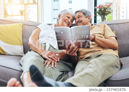 Senior, relax and a couple reading a book on the sofa for learning together. Smile, love and an elderly man and woman with a novel or story on a home living room couch for knowledge in retirement 137465876