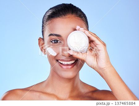 Skincare, cream and cosmetics with portrait of woman in studio for beauty, facial or moisturizer. Spa, health and collagen with face of person on blue background for product, glow or sunscreen Skincare, cream and cosmetics with portrait of woman in studio for beauty, facial or moisturizer. Spa, health and collagen with face of person on blue background for product, glow or sunscreen 137465884