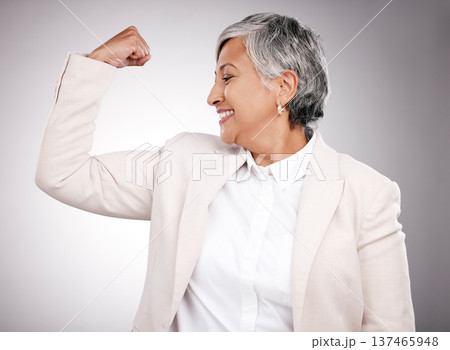 Strong, smile and mature businesswoman in a studio with strength, feminism or confidence gesture. Happy, empowerment and female model from Mexico flexing her arm muscles for emoji by gray background. Strong, smile and mature businesswoman in a studio with strength, feminism or confidence gesture. Happy, empowerment and female model from Mexico flexing her arm muscles for emoji by gray background. 137465948