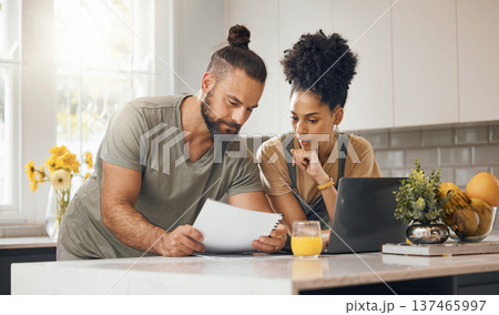 Interracial couple, laptop in kitchen and insurance paperwork, budget and finance with life and marriage. Partner, people at home and reading document with policy, taxes and bills with mortgage Interracial couple, laptop in kitchen and insurance paperwork, budget and finance with life and marriage. Partner, people at home and reading document with policy, taxes and bills with mortgage 137465997