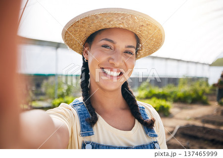 Selfie, smile and a woman in a farm greenhouse for agriculture or natural sustainability in the harvest season. Portrait, farming and a happy young female farmer in a garden for eco friendly growth Selfie, smile and a woman in a farm greenhouse for agriculture or natural sustainability in the harvest season. Portrait, farming and a happy young female farmer in a garden for eco friendly growth 137465999