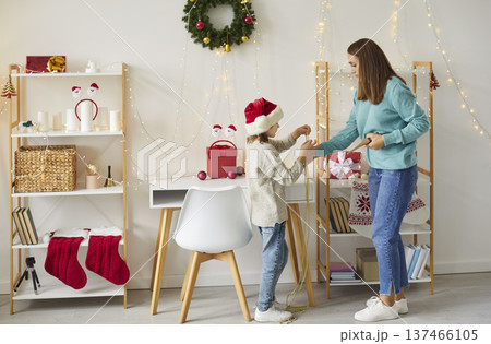 Mother And Child Decorating The Home For Christmas Or New Year Together Mother And Child Decorating The Home For Christmas Or New Year Together 137466105