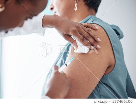 Medicine, healthcare and doctor with woman for vaccination in a clinic for medical treatment for prevention. Closeup of a nurse doing a vaccine injection with a needle syringe in a medicare hospital. Medicine, healthcare and doctor with woman for vaccination in a clinic for medical treatment for prevention. Closeup of a nurse doing a vaccine injection with a needle syringe in a medicare hospital. 137466106