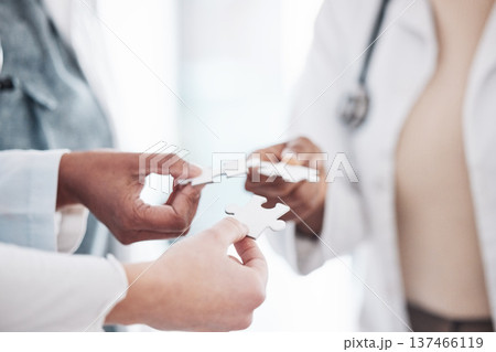 Doctor, team and hands with puzzle piece connection for solidarity, medical community and teamwork. Hospital, clinic and healthcare group with engagement, support and development of surgeon staff 137466119