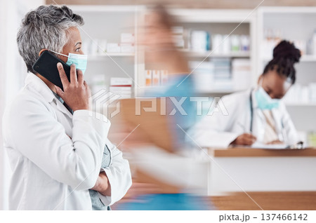 Woman, pharmacist and phone call with face mask in Telehealth, consultation or conversation at pharmacy. Female person or medical healthcare professional talking on mobile smartphone in online advice 137466142