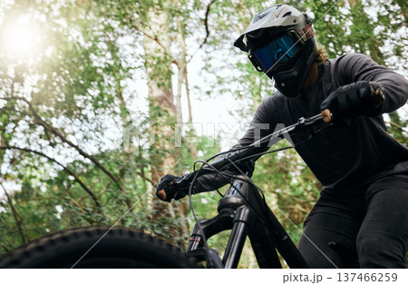 Bicycle, forest and man travel, exercise and workout outdoor in woods for healthy body. Mountain bike, nature and athlete training, cycling and off road adventure on journey, freedom or sunset sport 137466259