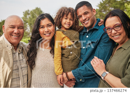 Happy family, grandparents and parent with kid in a park together and happy for vacation or outdoor vacation. Smile, portrait and mother bonding with child and father in nature for summer travel 137466274