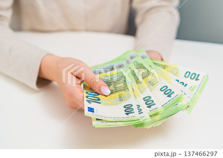 Close up of woman counting euro bills. Concept of budgeting, salary income, personal finance, savings and household money management. 137466297
