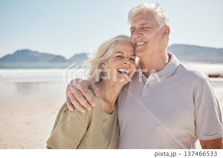 Senior couple, hug and love at the beach with happiness, freedom and care on vacation. Man and woman laughing on retirement holiday, adventure and romantic trip outdoor in nature to relax and travel 137466533