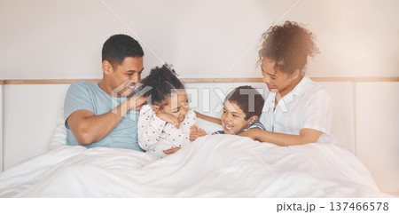 Happy, tickle and relax with family in bedroom for playful, morning and love. Care, support and wake up with parents and children laughing in bed at home for weekend, positive and resting together 137466578