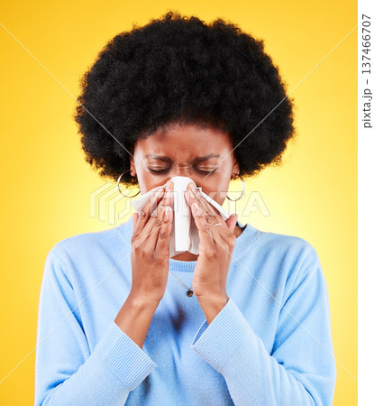 Nose, sneeze and sick woman in studio for cold, allergies and risk of medical virus on yellow background. African model, tissue and ill health of sinusitis, allergy and bacteria of winter infection Nose, sneeze and sick woman in studio for cold, allergies and risk of medical virus on yellow background. African model, tissue and ill health of sinusitis, allergy and bacteria of winter infection 137466707