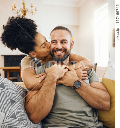 Happy couple, hug and kiss on sofa in home, living room or bonding in apartment with love in marriage or relationship. Man, smile and woman embrace or support partner on couch or relax together 137466746