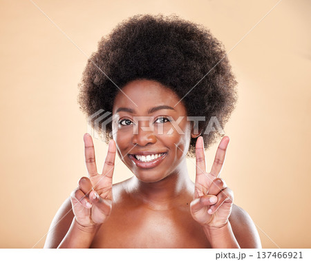 Portrait, beauty or peace sign for skincare with a black woman in studio on beige background. Face, smile and hand gesture with a happy young afro model posing for natural cosmetics or transformation Portrait, beauty or peace sign for skincare with a black woman in studio on beige background. Face, smile and hand gesture with a happy young afro model posing for natural cosmetics or transformation 137466921