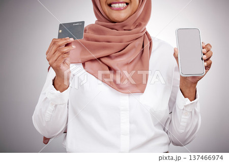 Woman, hands and credit card with phone screen, fashion e commerce and online shopping mockup in studio. Happy muslim or islamic person with mobile fintech, banking and payment on a white background Woman, hands and credit card with phone screen, fashion e commerce and online shopping mockup in studio. Happy muslim or islamic person with mobile fintech, banking and payment on a white background 137466974