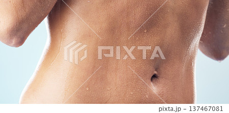 Body care, cleaning and stomach of woman in a shower for wellness, hygiene and skincare in studio closeup. Water splash, zoom and abdomen of female model in bathroom for beauty, routine or daily care 137467081