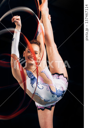 Woman, portrait and happy for ribbon gymnastics, sports performance or competition on black background. Flexible athlete, dancer and smile for agile showcase, talent and rhythmic contest in studio Woman, portrait and happy for ribbon gymnastics, sports performance or competition on black background. Flexible athlete, dancer and smile for agile showcase, talent and rhythmic contest in studio 137467114