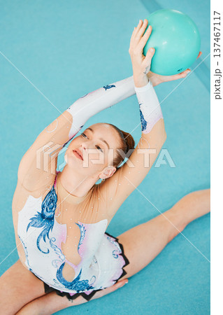 Woman, ball and stretching for gymnastics competition, performance and showcase solo concert from above. Flexible dancer, rhythm and agile athlete with talent, balance and action in contest arena Woman, ball and stretching for gymnastics competition, performance and showcase solo concert from above. Flexible dancer, rhythm and agile athlete with talent, balance and action in contest arena 137467117