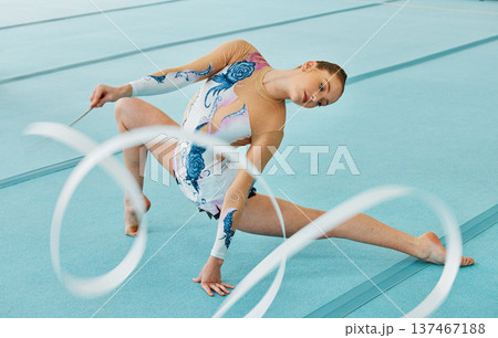 Woman, ribbon gymnastics and action for performance, sports competition and solo concert. Flexible dancer, rhythm and creative training of athlete with talent, energy and agile skill in contest arena Woman, ribbon gymnastics and action for performance, sports competition and solo concert. Flexible dancer, rhythm and creative training of athlete with talent, energy and agile skill in contest arena 137467188
