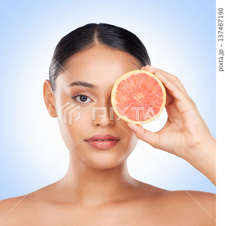 Beauty skincare, portrait and woman with grapefruit for organic collagen treatment, natural self care or fruit benefits. Vitamin C, citrus product or studio face of wellness person on blue background Beauty skincare, portrait and woman with grapefruit for organic collagen treatment, natural self care or fruit benefits. Vitamin C, citrus product or studio face of wellness person on blue background 137467190