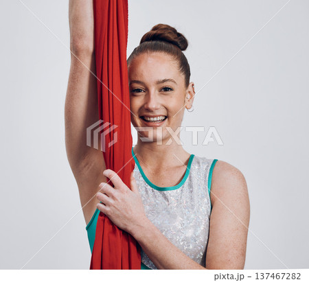 Portrait, ribbon dancer and competition with a woman in studio on a gray background for routine training. Fitness, smile and energy with a happy athlete holding fabric for a performance showcase Portrait, ribbon dancer and competition with a woman in studio on a gray background for routine training. Fitness, smile and energy with a happy athlete holding fabric for a performance showcase 137467282