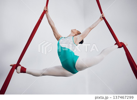 Gymnast, woman acrobat with performance and sports, fitness and art with athlete on white background. Gymnastics, training and exercise with creativity, talent with fabric and competition in studio 137467299