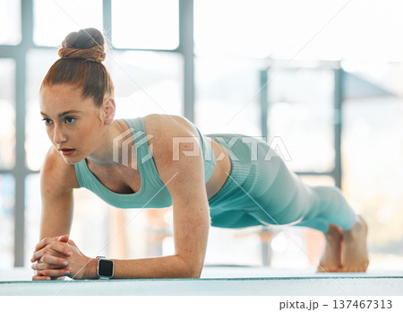 Workout, woman and serious for plank exercise in gym for strong core, training and balance of fitness. Athlete, active and control body on elbow for push up, sports challenge or muscle power on floor Workout, woman and serious for plank exercise in gym for strong core, training and balance of fitness. Athlete, active and control body on elbow for push up, sports challenge or muscle power on floor 137467313