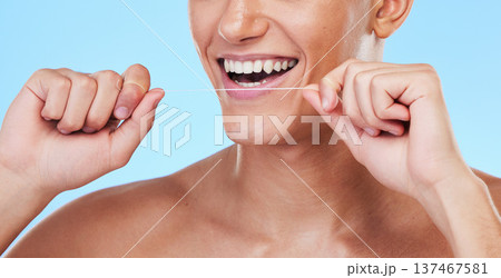 Happy man, dental floss and cleaning teeth in oral hygiene or grooming against a blue studio background. Closeup of male person with big smile in flossing, tooth whitening or gum and mouth care 137467581