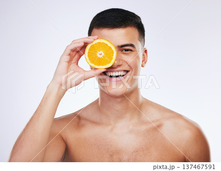 Beauty, orange and smile with portrait of man in studio for health, skincare and natural cosmetics. Vitamin c, nutrition and summer with face of person and fruit on white background for self care Beauty, orange and smile with portrait of man in studio for health, skincare and natural cosmetics. Vitamin c, nutrition and summer with face of person and fruit on white background for self care 137467591