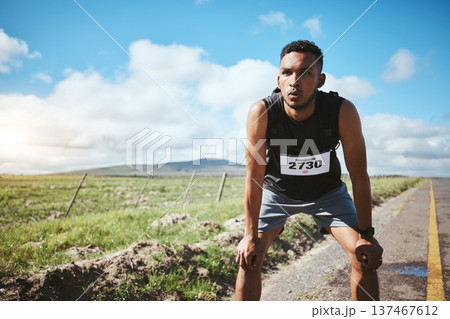 Tired, sports and man with fitness, wellness or exhausted with workout, breathing or training. Person, runner or athlete outdoor, exercise or fatigue with rest, challenge or sweat with intense cardio 137467612