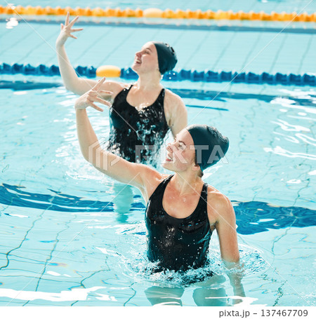 Synchronized, swimming and women in competition performance, event or dance together in pool, water or sport. Athlete, swimmer and people training for concert, dancing or duet or stretching arms 137467709