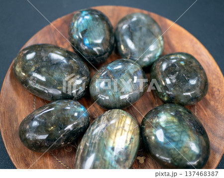 Exquisite collection of labradorite stones showcasing their stunning iridescence. Unique gemstones capture and reflect light Exquisite collection of labradorite stones showcasing their stunning iridescence. Unique gemstones capture and reflect light 137468387