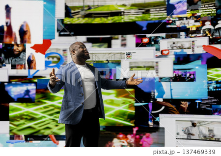 African American public speaker on stage surrounded by digital visuals, symbolizing a global conference where trends, mobile apps and AI powered content dominate modern communication. 137469339