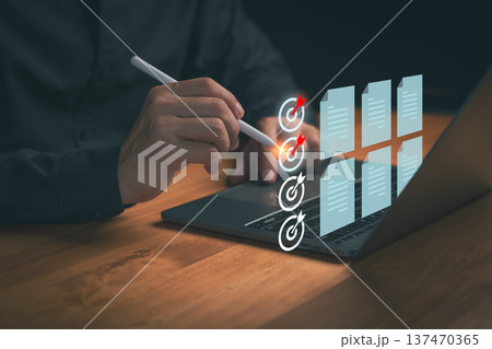Person using a digital pen on a laptop to targets and review digital documents, illustrating workflow optimization, task completion, productivity planning, and data organization in a modern workspace. Person using a digital pen on a laptop to targets and review digital documents, illustrating workflow optimization, task completion, productivity planning, and data organization in a modern workspace. 137470365