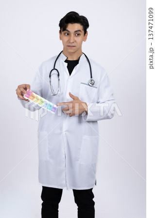 Smiling doctor holding various medical pills and vitamins 137471099