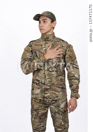 Soldier in camouflage uniform with hand on his heart Soldier in camouflage uniform with hand on his heart 137471170