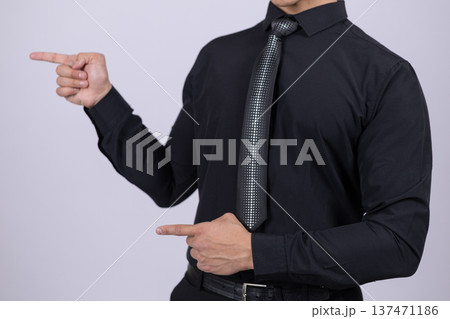 Man pointing finger to the side on white background Man pointing finger to the side on white background 137471186