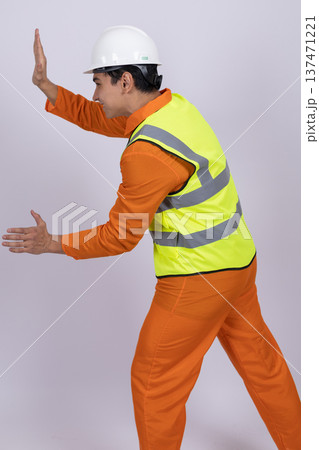 Builder pushing an invisible wall in a studio 137471221