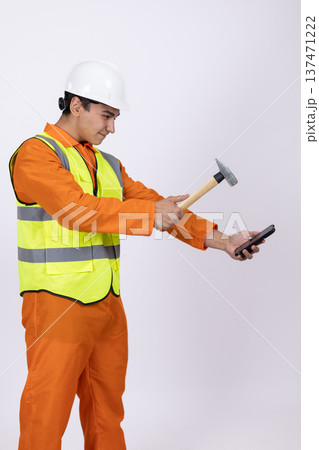 Construction worker using a hammer and a level 137471222