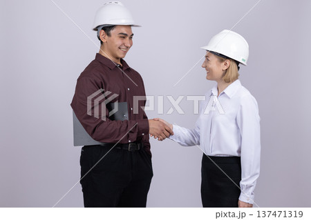 Construction workers shaking hands in a studio Construction workers shaking hands in a studio 137471319