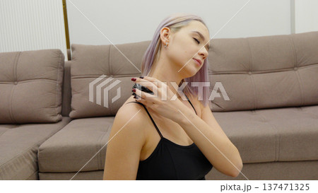 Girl using deodorant spray on her underarm at home Girl using deodorant spray on her underarm at home 137471325