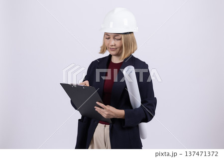 Female manager in dark suit holding a digital tablet in studio Female manager in dark suit holding a digital tablet in studio 137471372