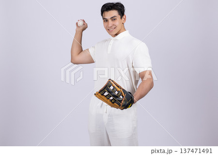 Young man holding a baseball ball and wearing glove Young man holding a baseball ball and wearing glove 137471491