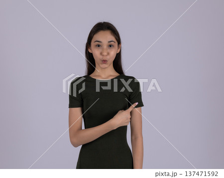 Young woman in black t-shirt pointing at herself in studio Young woman in black t-shirt pointing at herself in studio 137471592