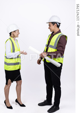 Male and female engineers discussing construction project 137471795