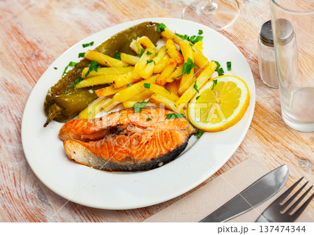 Grilled salmon with pepper and french fries 137474344